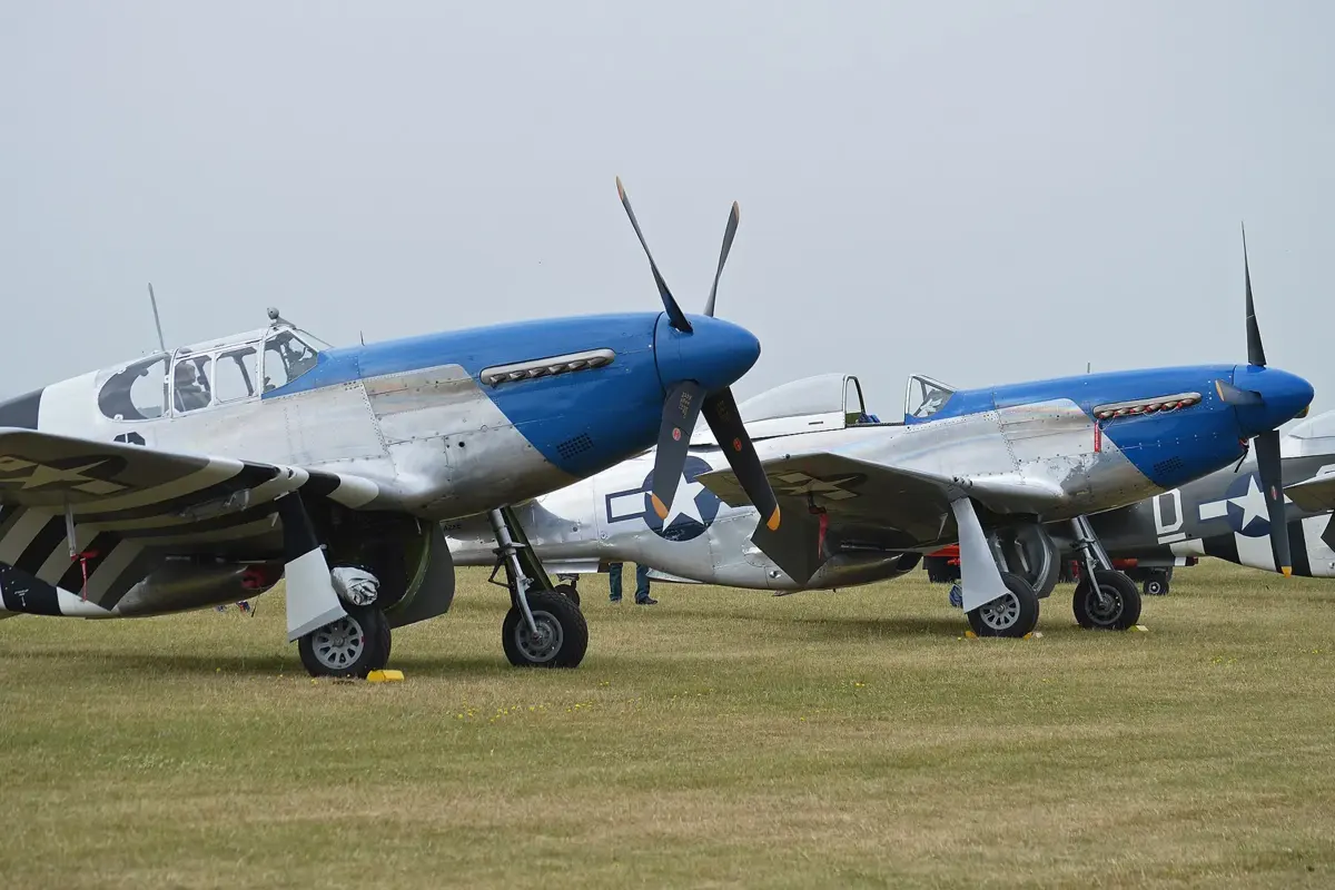 P-51 Mustangs flying in formation at an airshow