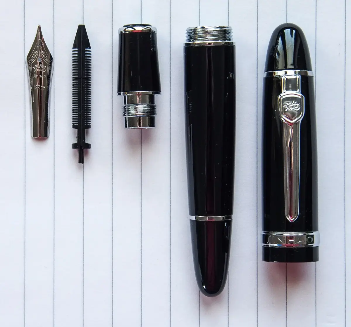 A disassembled fountain pen showing its parts