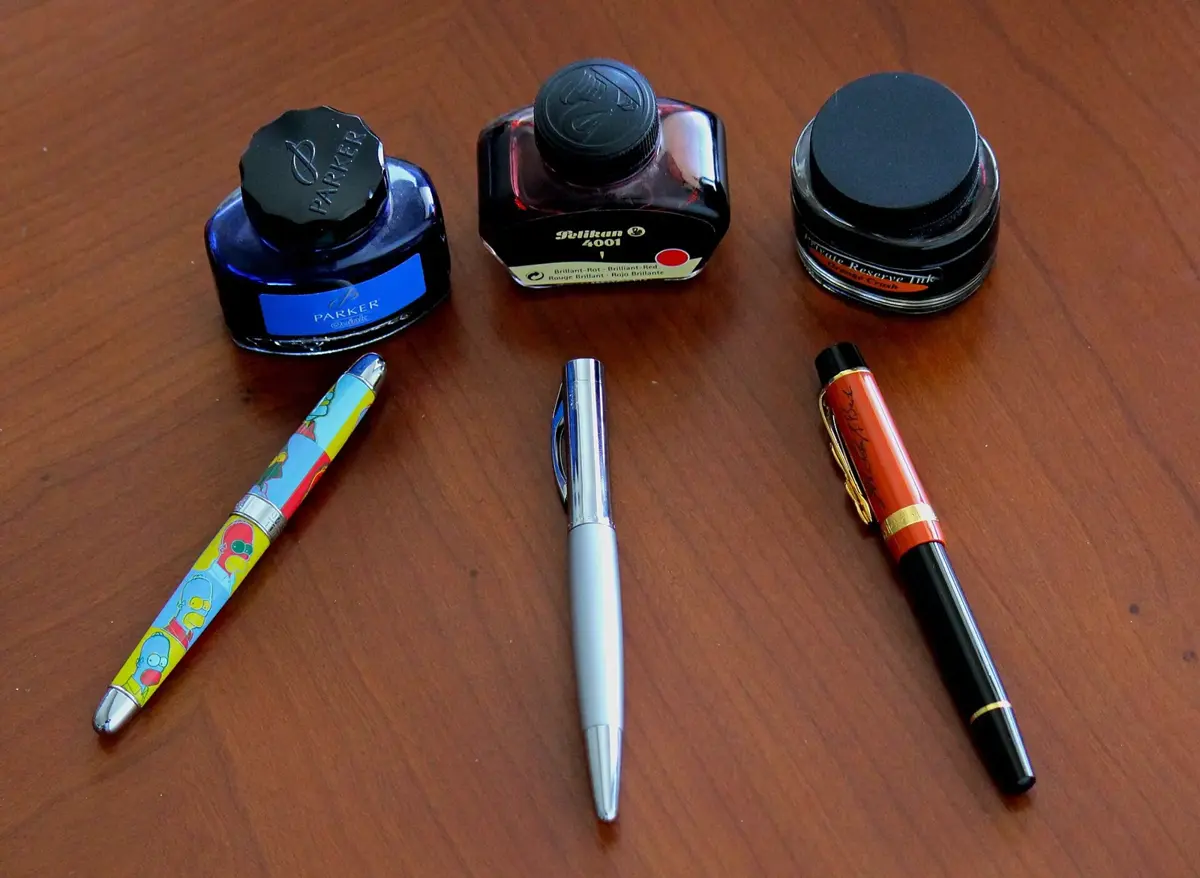 Fountain pens with bottles of ink