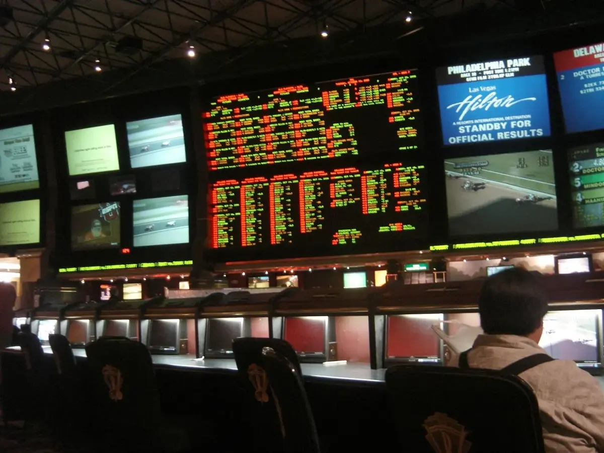 The race and sportsbook at a Las Vegas casino, with odds boards above rows of seats